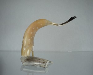 Muskox horn carving of a crane with an arched neck